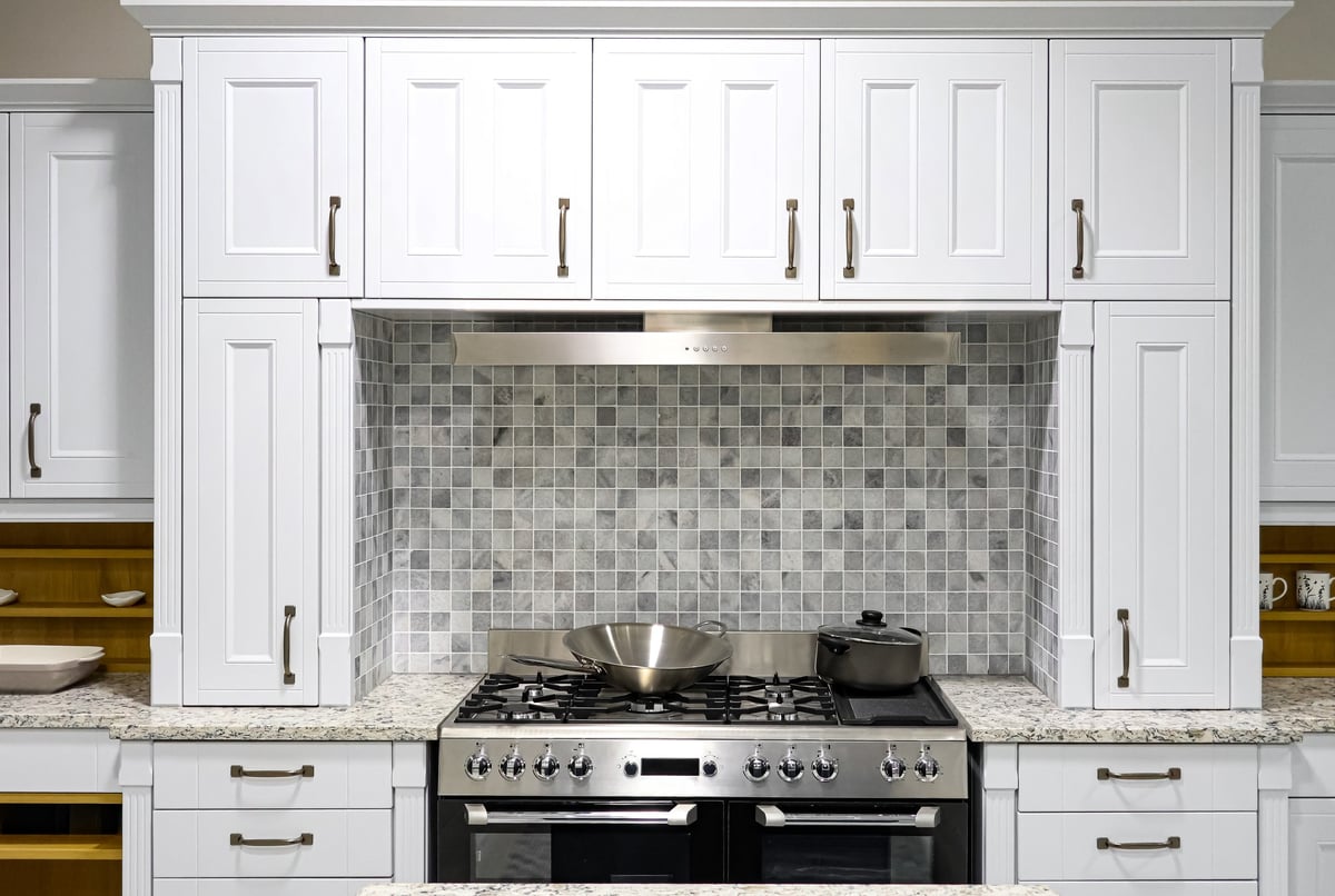 Contemporary kitchen with white cabinets installed